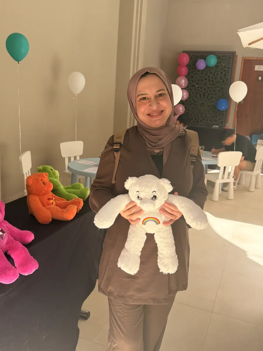 Party guest holding a white YogaBears character at a Dubai kids' birthday party