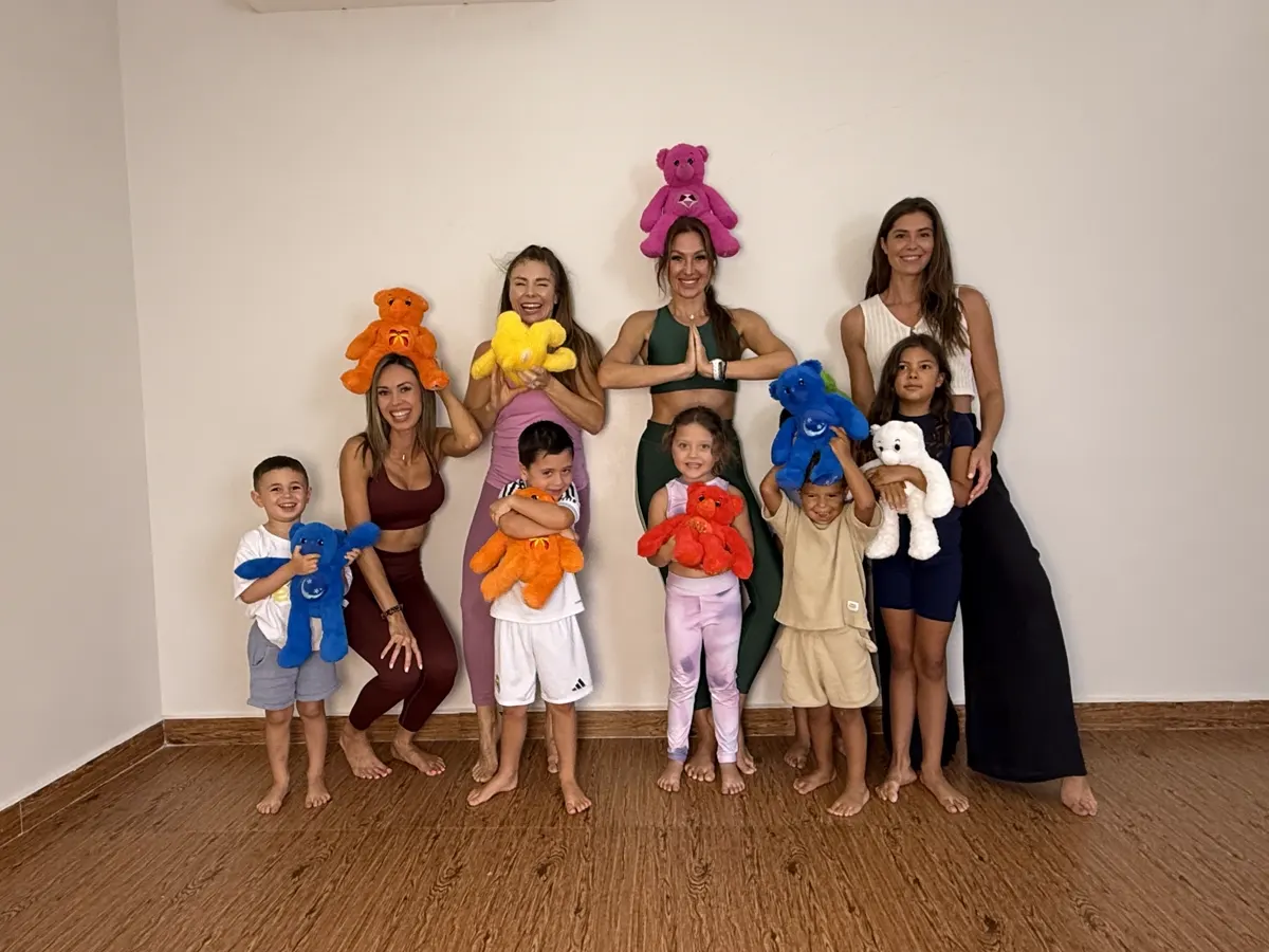 YogaBears instructors and children group photo with plush characters