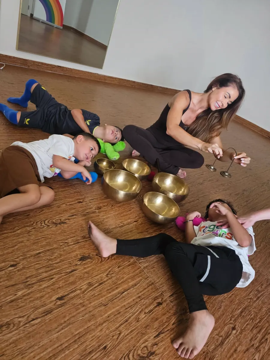 Children taking part in a calming sound bath session led by YogaBears instructors